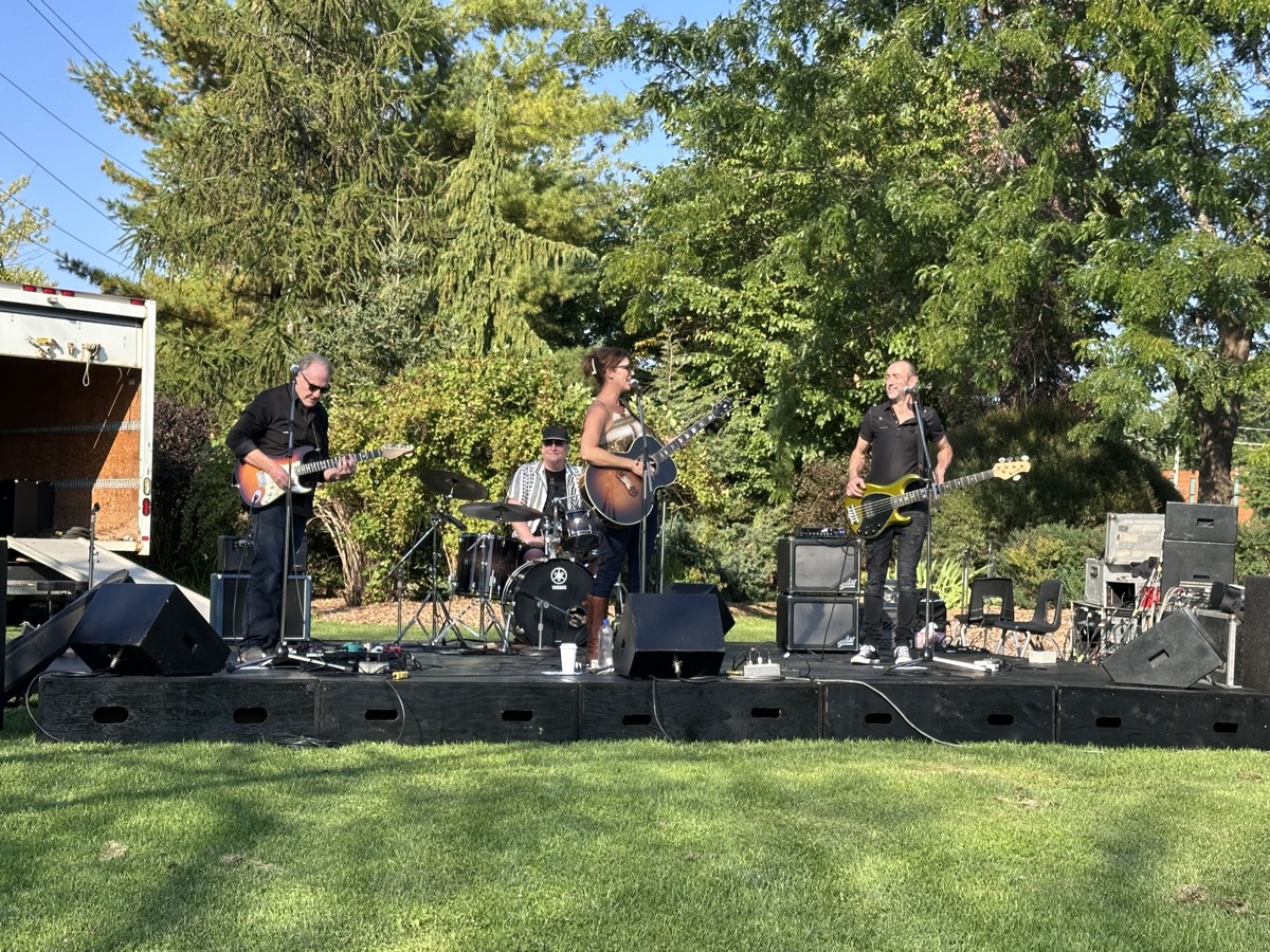 Karla Crawford Music performing at an outdoor park stage
